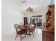 The dining room offers a rustic wood table set with bright, natural lighting and backyard patio access at 18302 Burkholder Cir, Port Charlotte, FL 33948