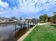 A private boat lift provides easy access to the canal, with meticulously manicured lawn at 18302 Burkholder Cir, Port Charlotte, FL 33948