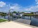 Private boat dock with a boat lift and a picturesque waterfront setting at 18302 Burkholder Cir, Port Charlotte, FL 33948