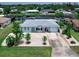 Charming waterfront home with a light blue exterior and well-maintained landscaping at 18302 Burkholder Cir, Port Charlotte, FL 33948