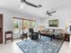 Cozy living room with plush seating, ceiling fans, and large windows for natural light at 18302 Burkholder Cir, Port Charlotte, FL 33948