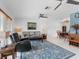 Spacious living room featuring an open layout, tiled floors, and comfortable seating arrangement at 18302 Burkholder Cir, Port Charlotte, FL 33948