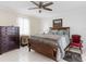 Comfortable main bedroom with a ceiling fan and soothing decor at 18302 Burkholder Cir, Port Charlotte, FL 33948