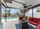 Screened patio with a fire pit, water view and outdoor seating area at 18302 Burkholder Cir, Port Charlotte, FL 33948
