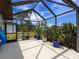 The expansive outdoor patio provides an open-air space with lush foliage, ideal for entertaining at 18302 Burkholder Cir, Port Charlotte, FL 33948