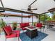Covered patio area with an outdoor kitchen and outdoor seating with a nice outdoor view at 18302 Burkholder Cir, Port Charlotte, FL 33948