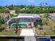 Waterfront home featuring screened-in pool, boat dock and spacious backyard at 18302 Burkholder Cir, Port Charlotte, FL 33948