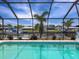 Tranquil waterfront views from the pool, set against a backdrop of lush greenery and serene canals at 18302 Burkholder Cir, Port Charlotte, FL 33948