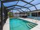 A stunning screened pool, with clear blue water, offers a refreshing retreat and entertaining area at 18302 Burkholder Cir, Port Charlotte, FL 33948