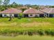 Aerial view of the homes and surrounding landscaping, including a waterfront view at 20636 Swallowtail Ct, Venice, FL 34293