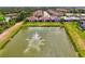 Aerial view of the homes around the pond with fountain at 20636 Swallowtail Ct, Venice, FL 34293