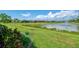 Lush backyard with manicured lawn and pond view at 20636 Swallowtail Ct, Venice, FL 34293