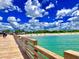 Serene beach view from the pier with clear blue waters and a sandy shoreline, perfect for a relaxing day at 20636 Swallowtail Ct, Venice, FL 34293
