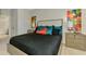Bedroom featuring a bed with stylish pillows, neutral walls, and decorative art at 20636 Swallowtail Ct, Venice, FL 34293