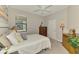 Bedroom showcasing a comfortable bed, natural light from the window, and classic wooden furniture at 20636 Swallowtail Ct, Venice, FL 34293