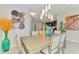 Dining room adjacent to the kitchen with colorful decor and modern chandelier at 20636 Swallowtail Ct, Venice, FL 34293