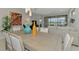 Dining room with stylish decor, offering views of the living area and lake at 20636 Swallowtail Ct, Venice, FL 34293