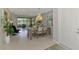 Inviting dining area with elegant chandelier and serene outdoor views at 20636 Swallowtail Ct, Venice, FL 34293