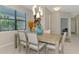Dining space with decorative vases, modern chandelier, and bright window at 20636 Swallowtail Ct, Venice, FL 34293