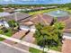 Paver driveways lead to garages and manicured lawns in a lovely residential neighborhood near a tranquil lake at 20636 Swallowtail Ct, Venice, FL 34293