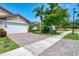 Charming home showcases a paver driveway, a spacious two-car garage, and meticulously maintained landscaping at 20636 Swallowtail Ct, Venice, FL 34293