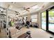 Well-equipped fitness center with various machines and ample natural light at 20636 Swallowtail Ct, Venice, FL 34293