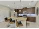 Kitchen island with granite countertops, pendant lighting, and seating for three; stainless steel appliances at 20636 Swallowtail Ct, Venice, FL 34293