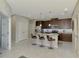 Beautiful kitchen island with granite countertops and modern stainless steel appliances and three bar stools at 20636 Swallowtail Ct, Venice, FL 34293