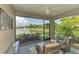 Screened-in lanai with comfortable seating overlooking a serene pond and fountain at 20636 Swallowtail Ct, Venice, FL 34293