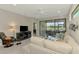 Cozy living room with stylish decor, featuring a screened-in porch and lake view at 20636 Swallowtail Ct, Venice, FL 34293