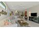 Bright living room with large sectional couch and modern decor throughout the open floor plan at 20636 Swallowtail Ct, Venice, FL 34293