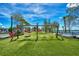Fun community playground area with swings and green space, perfect for families and children to enjoy the outdoors at 20636 Swallowtail Ct, Venice, FL 34293