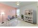 Bright home office with a sleek desk, modern shelving, and a comfortable workspace at 21057 Anclote Ct, Venice, FL 34293