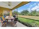 Relaxing screened patio with a dining table, chairs, and views of the lush backyard at 21057 Anclote Ct, Venice, FL 34293