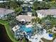 Aerial view of community pool with palm trees and waterfall feature near clubhouse at 212 Triano Cir # 212, Venice, FL 34292