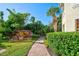 Backyard path and lush landscaping with a stone waterfall feature, creating a private oasis at 212 Triano Cir # 212, Venice, FL 34292