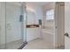Bathroom featuring a glass shower, vanity, soaking tub, and neutral tile flooring at 212 Triano Cir # 212, Venice, FL 34292