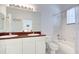 Bathroom featuring a double vanity with solid surface countertops, toilet and shower-tub combination at 212 Triano Cir # 212, Venice, FL 34292