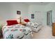 Cozy bedroom with twin beds, warm lighting, and adjacent bathroom and closet at 212 Triano Cir # 212, Venice, FL 34292
