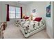 Cozy bedroom features twin beds with floral quilts and a large window with natural light at 212 Triano Cir # 212, Venice, FL 34292
