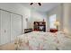 Comfortable bedroom with large closet, window with blinds, and a decorative bookshelf at 212 Triano Cir # 212, Venice, FL 34292