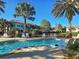 Inviting community pool featuring lounge chairs and palm trees for relaxation and leisure at 212 Triano Cir # 212, Venice, FL 34292