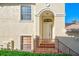 Charming entryway with a covered porch, decorative railing, and manicured landscaping at 212 Triano Cir # 212, Venice, FL 34292