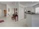 Inviting entryway with tiled floors, closet, and a glimpse of the kitchen and laundry room at 212 Triano Cir # 212, Venice, FL 34292