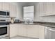 Efficient kitchen design with stainless steel appliances, granite countertops, and ample cabinet space at 212 Triano Cir # 212, Venice, FL 34292