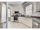 Modern kitchen with stainless steel appliances, granite countertops, and bright natural light at 212 Triano Cir # 212, Venice, FL 34292