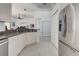 Open kitchen layout featuring stainless steel refrigerator and granite countertops at 212 Triano Cir # 212, Venice, FL 34292