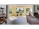 Bright lanai with tiled floors, potted plants, and views of lush landscaping through large windows at 212 Triano Cir # 212, Venice, FL 34292