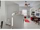 Bright living area with a ceiling fan, desk area, and view to a modern kitchen at 212 Triano Cir # 212, Venice, FL 34292