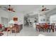 Open living room with high ceilings, tiled floors, and a view of the dining area and kitchen at 212 Triano Cir # 212, Venice, FL 34292